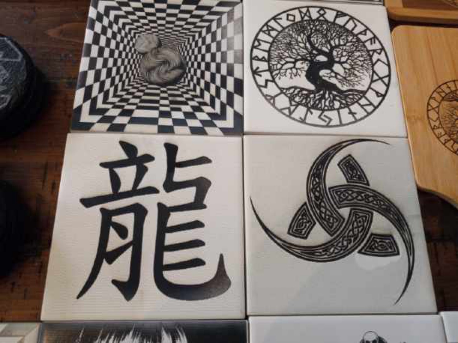 Tiles featuring optical illusion, Tree of Life, Chinese dragon character, and Celtic triskele